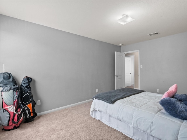 bedroom with carpet, visible vents, and baseboards