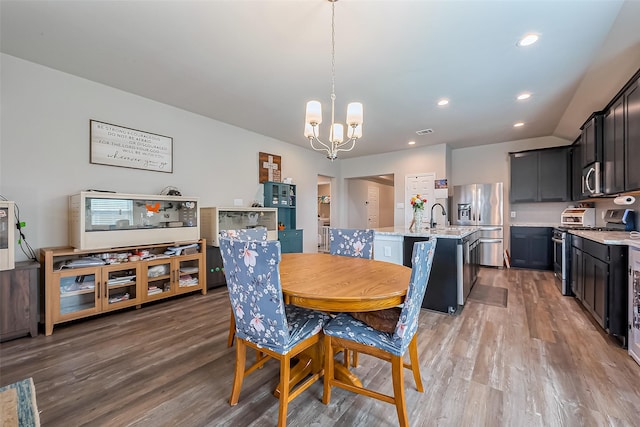 dining area featuring a notable chandelier, light wood finished floors, visible vents, and recessed lighting