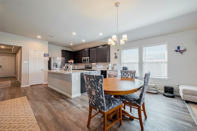 dining area with recessed lighting, wood finished floors, visible vents, and a notable chandelier