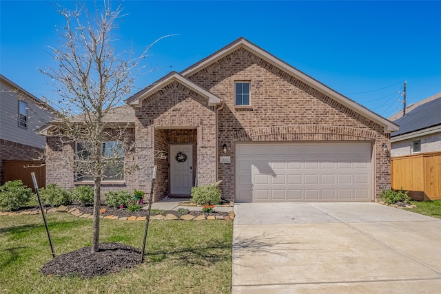 view of front facade with a garage, fence, concrete driveway, and brick siding