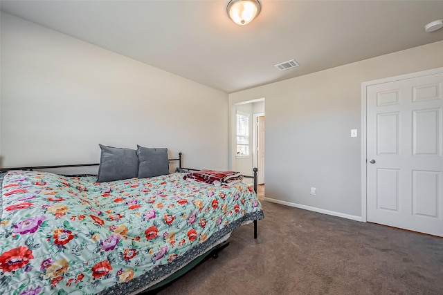 carpeted bedroom featuring visible vents and baseboards