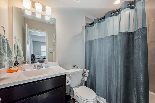 ensuite bathroom with visible vents, connected bathroom, vanity, and toilet