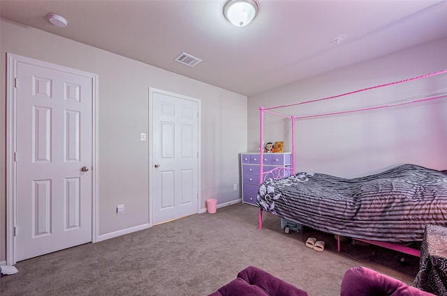 carpeted bedroom featuring visible vents and baseboards