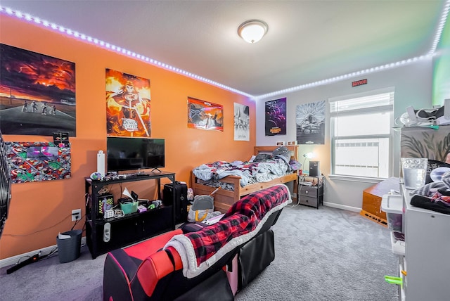 carpeted bedroom featuring baseboards