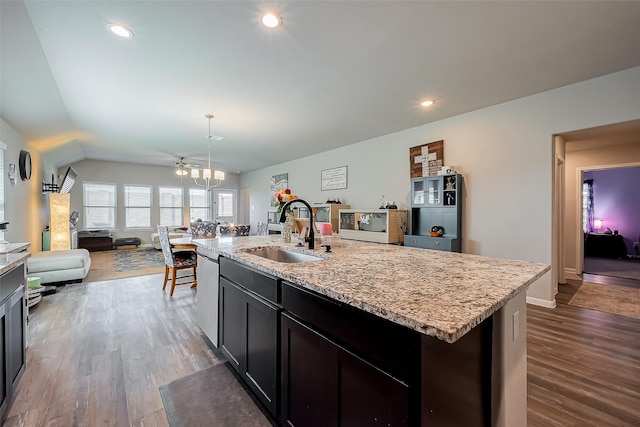 kitchen featuring dishwasher, dark wood-style floors, open floor plan, a sink, and recessed lighting