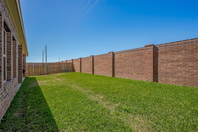 view of yard with a fenced backyard