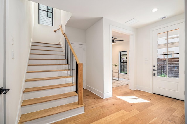 entrance foyer featuring stairs, wood finished floors, visible vents, and recessed lighting