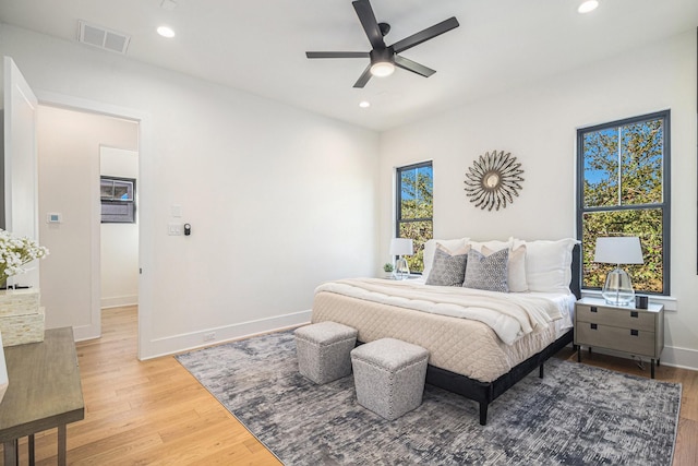 bedroom with light wood-type flooring, visible vents, and recessed lighting