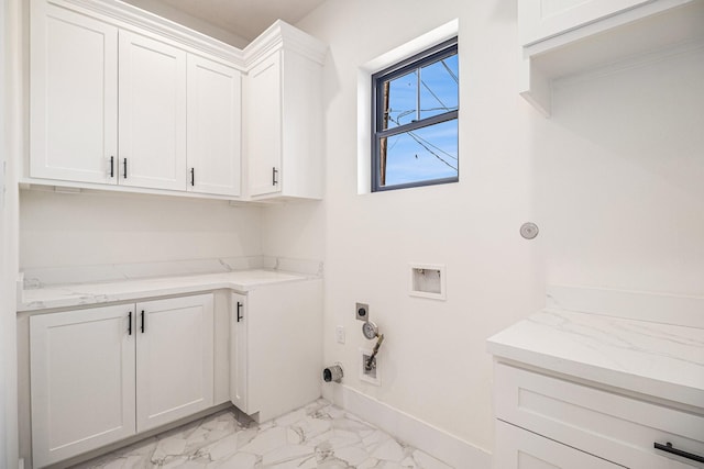 laundry room featuring washer hookup, marble finish floor, hookup for a gas dryer, cabinet space, and electric dryer hookup