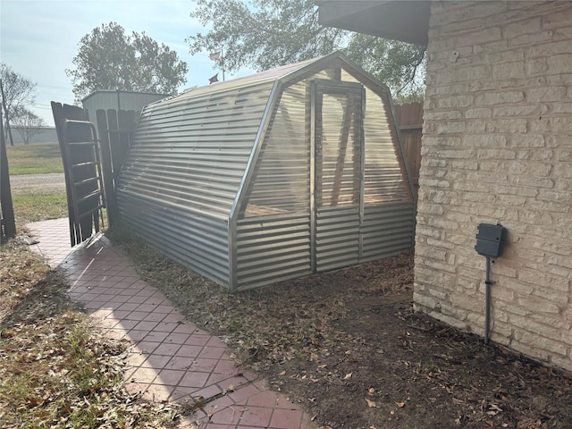 view of gate featuring an outdoor structure