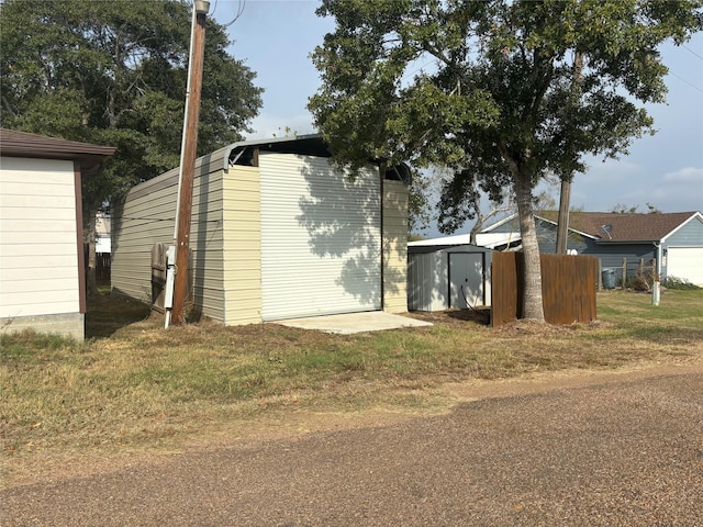 view of side of property with a storage unit and an outdoor structure