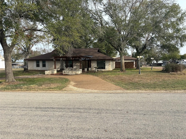 ranch-style house with a front yard and concrete driveway