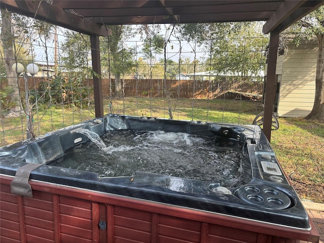 view of yard with fence and a hot tub