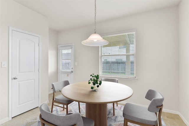 dining area with plenty of natural light and baseboards