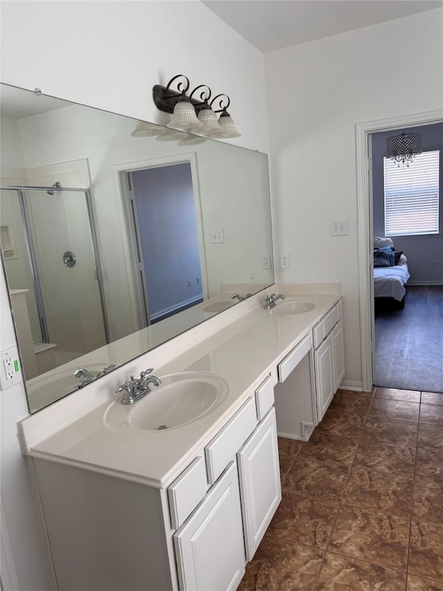 bathroom featuring double vanity, a shower stall, and a sink