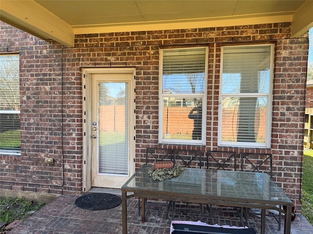 view of exterior entry with brick siding