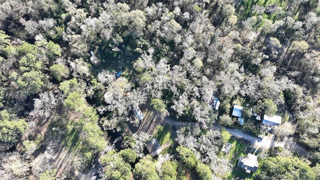 drone / aerial view featuring a wooded view