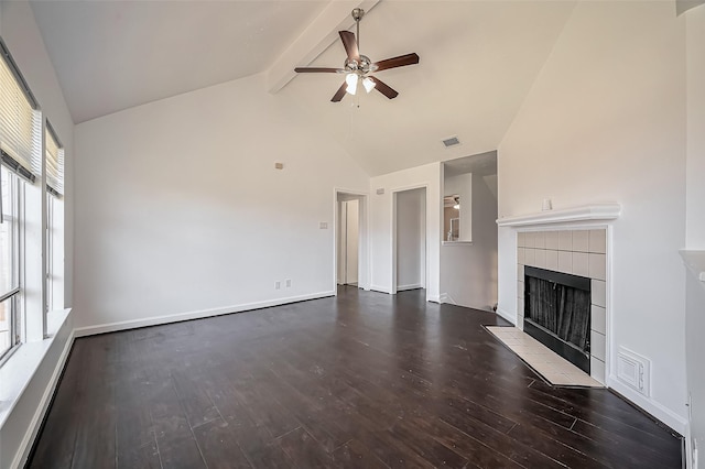 unfurnished living room with visible vents, a ceiling fan, wood finished floors, a tile fireplace, and beamed ceiling