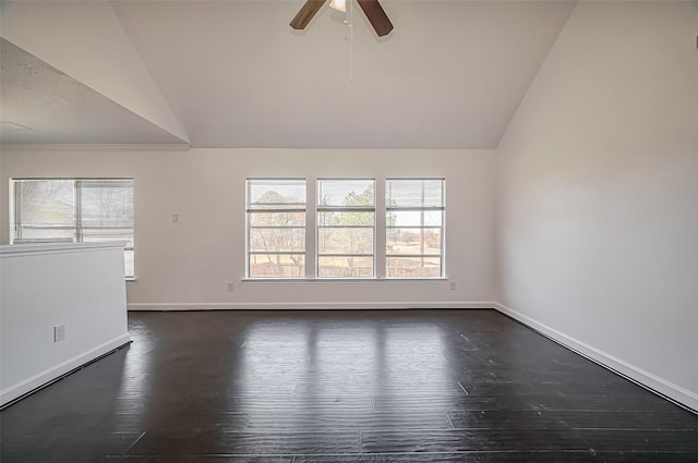 unfurnished room with lofted ceiling, dark wood finished floors, and baseboards