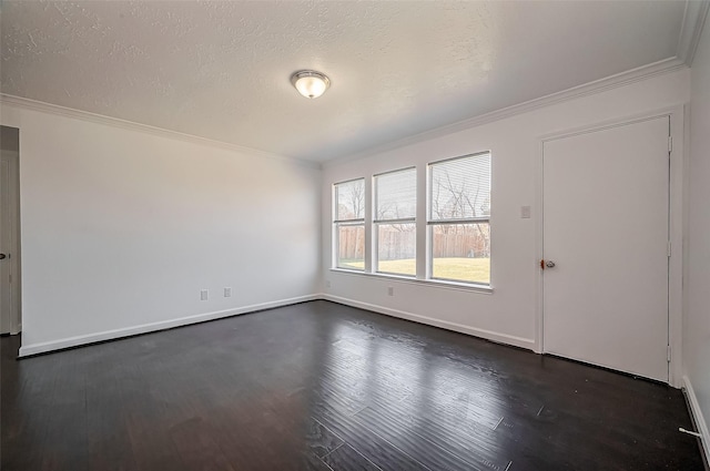 empty room featuring ornamental molding, a textured ceiling, and dark wood-style floors