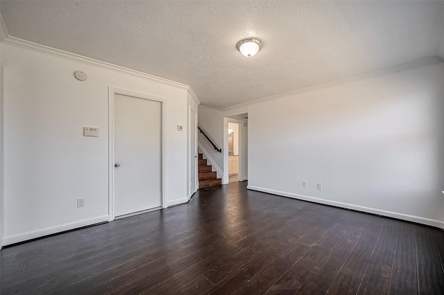 unfurnished room featuring stairway, crown molding, dark wood finished floors, and a textured ceiling