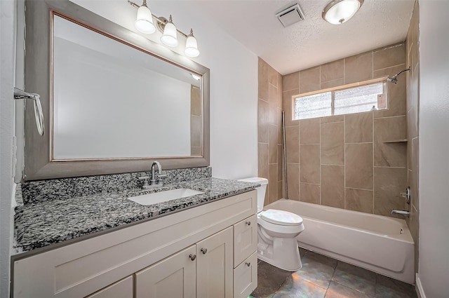 full bathroom featuring a textured ceiling, toilet, visible vents, tile patterned floors, and washtub / shower combination