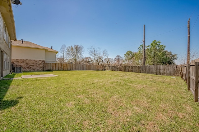 view of yard featuring a fenced backyard and central AC unit