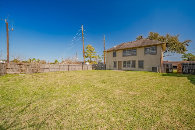 view of yard with central air condition unit and a fenced backyard