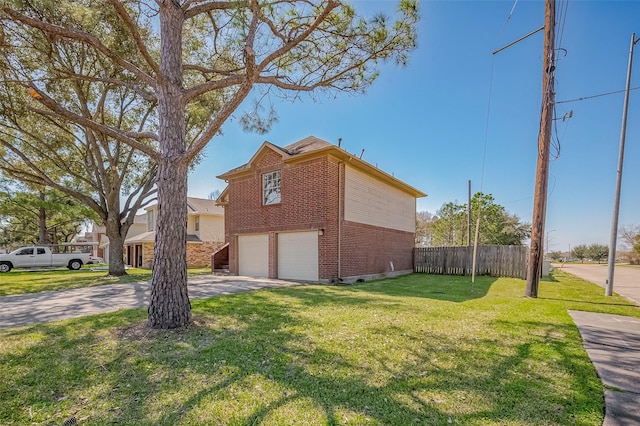 view of side of property with a lawn, concrete driveway, an attached garage, fence, and brick siding