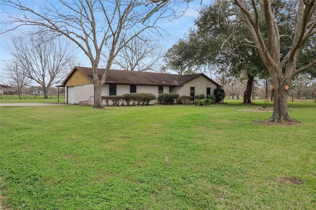 ranch-style house with a garage, a front lawn, and aphalt driveway