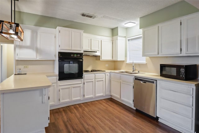 kitchen with dark wood-style flooring, visible vents, a sink, under cabinet range hood, and black appliances