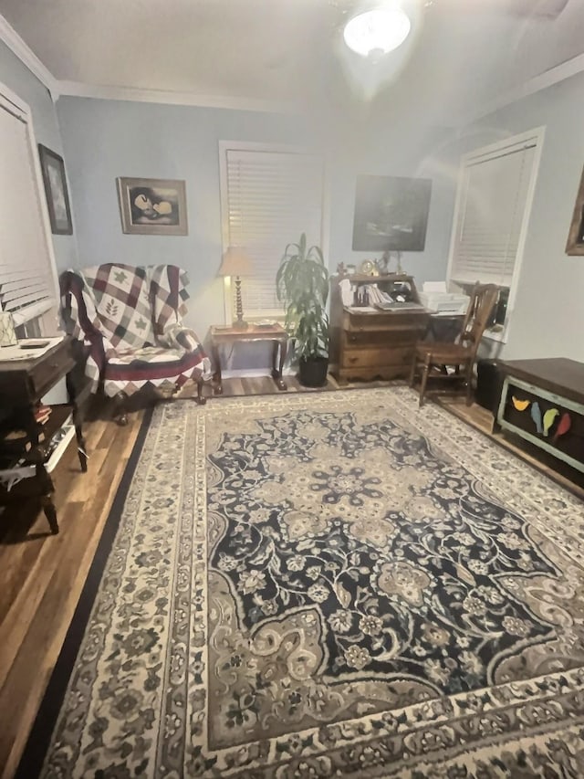 living area featuring wood finished floors and crown molding