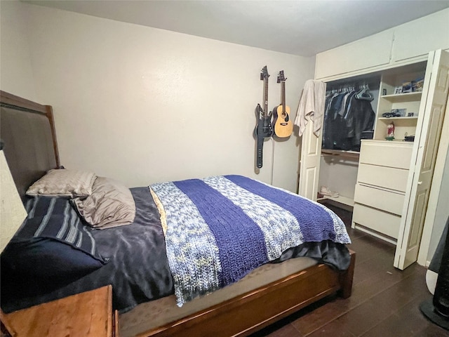 bedroom with a closet and dark wood-style flooring