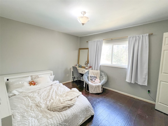 bedroom featuring wood-type flooring and baseboards