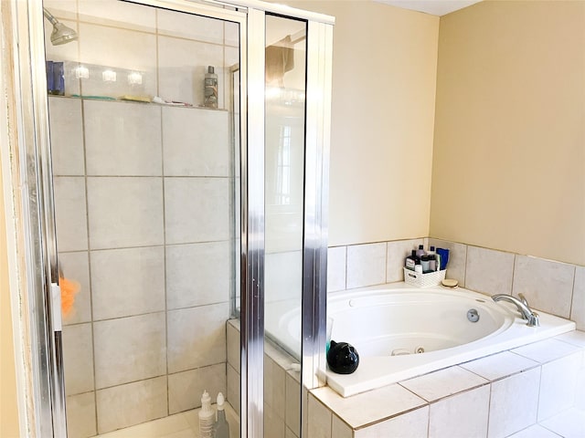 full bathroom with a whirlpool tub and a shower stall