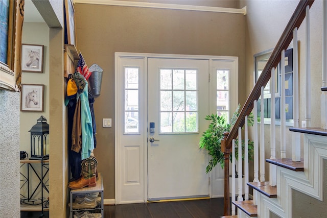 entrance foyer featuring dark wood finished floors and stairway