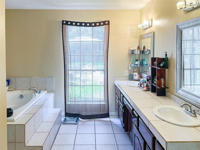 bathroom with a bath, tile patterned flooring, double vanity, and a sink