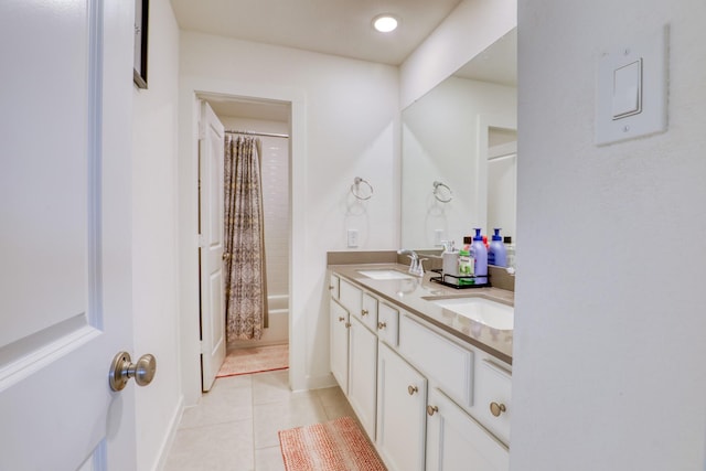 full bath featuring double vanity, shower / bathtub combination with curtain, a sink, and tile patterned floors