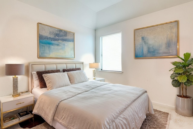 carpeted bedroom featuring baseboards