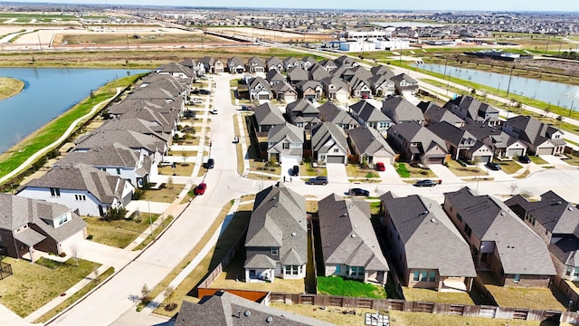 drone / aerial view with a water view and a residential view