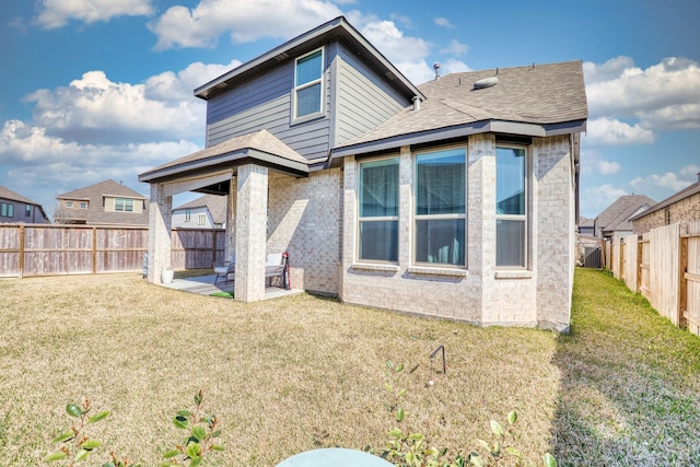 back of property with a patio area, a fenced backyard, a lawn, and brick siding