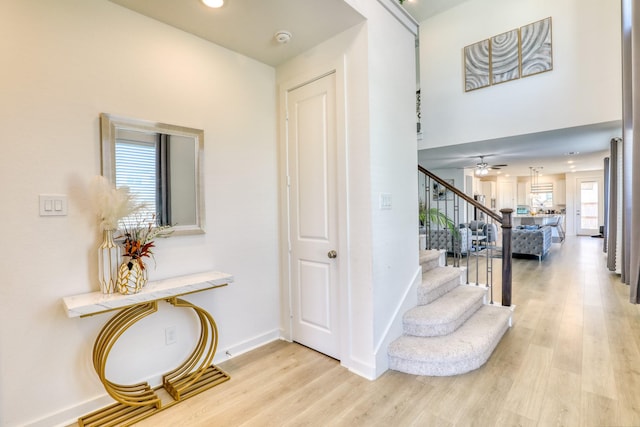 staircase with ceiling fan, recessed lighting, wood finished floors, and baseboards