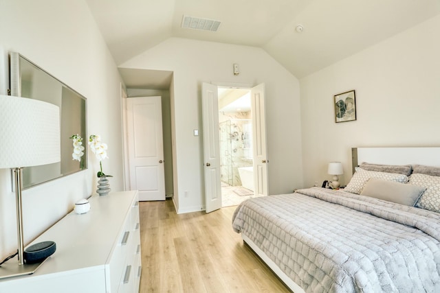 bedroom featuring visible vents, light wood-style flooring, connected bathroom, vaulted ceiling, and baseboards