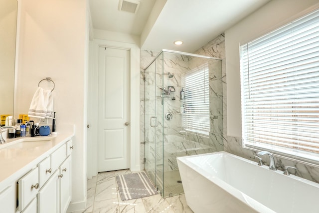 bathroom with marble finish floor, visible vents, a freestanding tub, and a marble finish shower