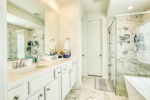 bathroom with a freestanding tub, a sink, visible vents, marble finish floor, and a marble finish shower