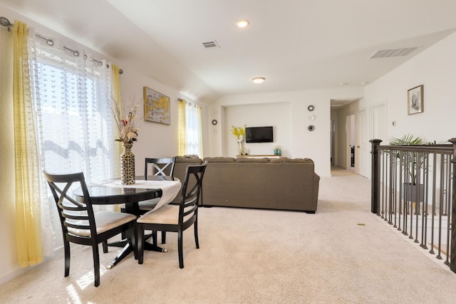 dining area featuring visible vents and light carpet