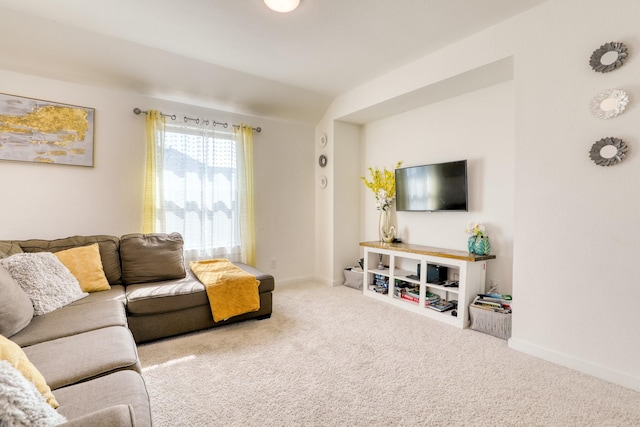 carpeted living room featuring baseboards