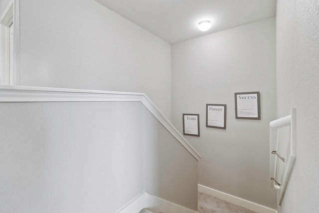 staircase with carpet floors and baseboards