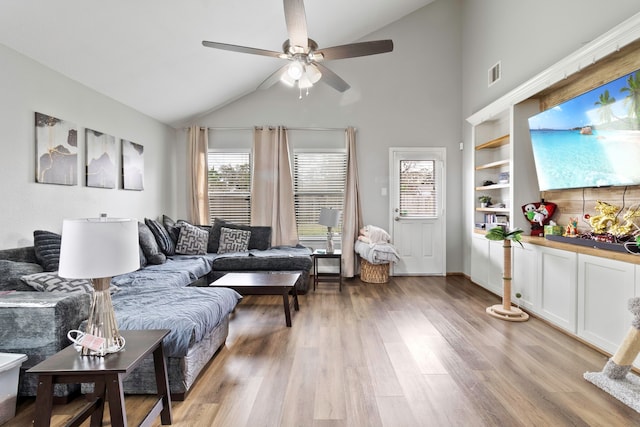 living area with light wood-style floors, visible vents, vaulted ceiling, and ceiling fan