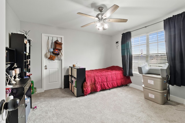 bedroom with a ceiling fan, carpet, and baseboards